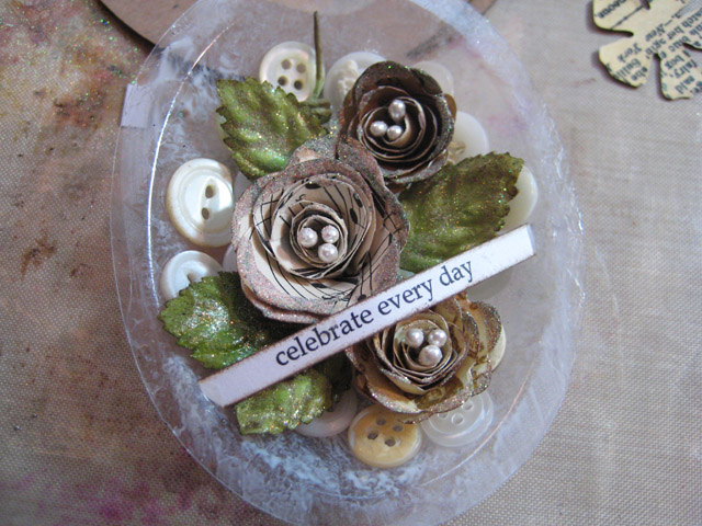 DIY Ornament: back globe with vintage buttons and 3D paper flowers.